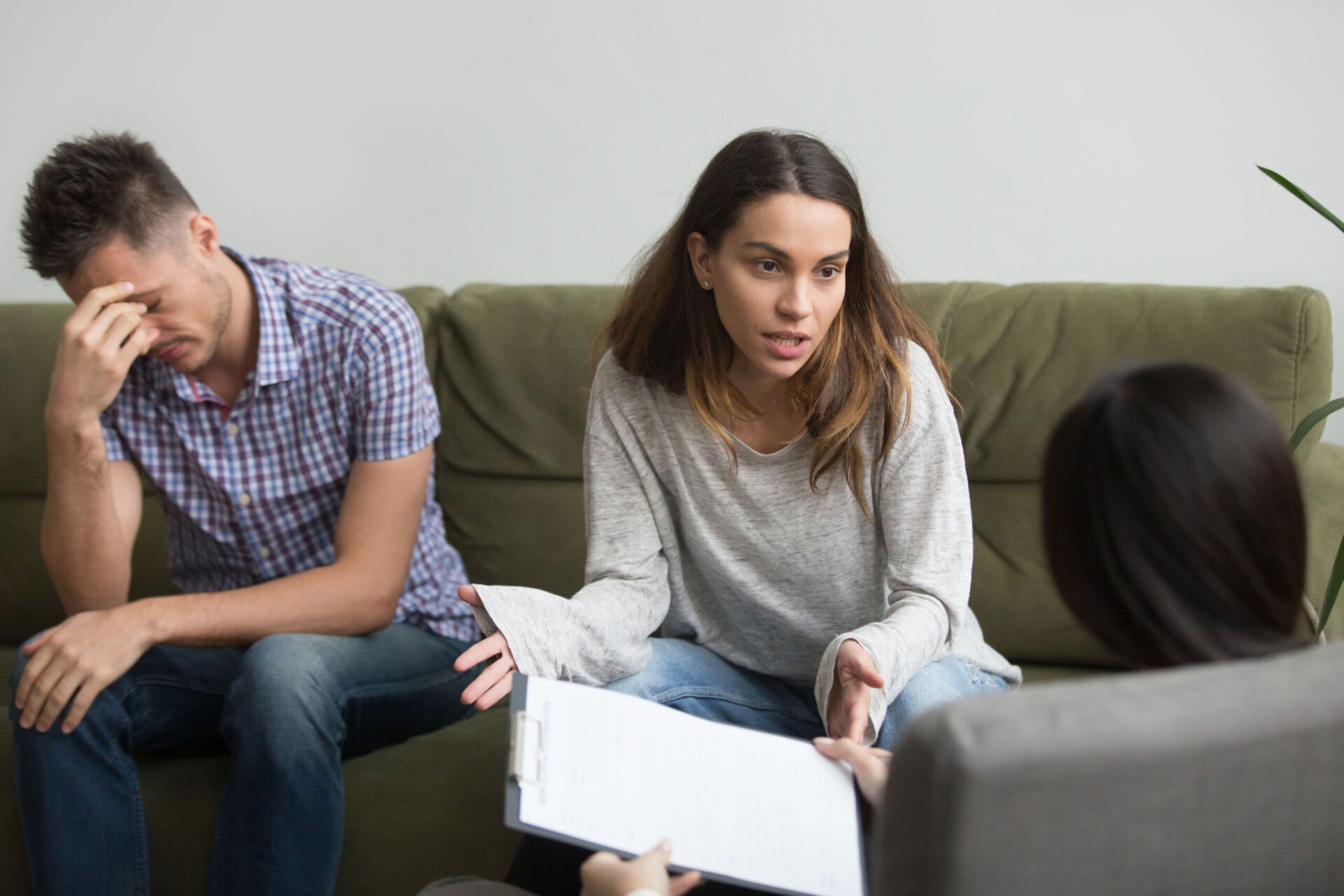 Unhappy frustrated woman sharing problems with counselor, couple